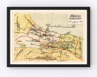 May include: An antique map of Istanbul, Turkey, with Arabic text and a detailed depiction of the city's layout. The map is framed in black and features a light yellow background with brown and red lines.