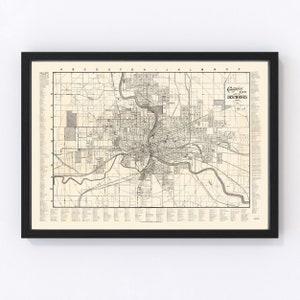 May include: A vintage map of Des Moines, Iowa, from the Commercial Club. The map shows the city's streets, parks, and other features. The map is in black and white and has a cream-colored background.