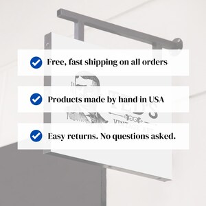 May include: White sign with three blue checkmarks and text. The text reads: "Free, fast shipping on all orders", "Products made by hand in USA", and "Easy returns. No questions asked."