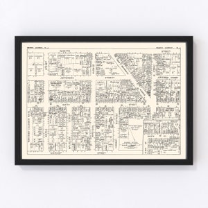 May include: A black and white map of Perth Amboy, New Jersey, showing street names and building lots. The map is framed in a black frame.