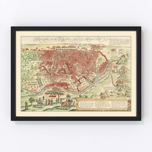May include: Framed vintage map print of a city, featuring a detailed illustration in red, green, and beige tones. The map includes a river, buildings, and figures, all within a black frame. The print is a historical representation.