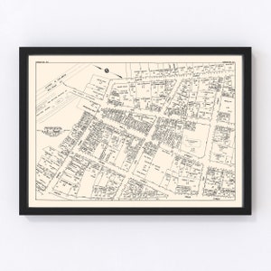 May include: A black and white map of the business section of the City of Paterson, New Jersey. The map shows the streets and blocks of the city, including the names of the streets and the numbers of the blocks. The map is dated 1921.