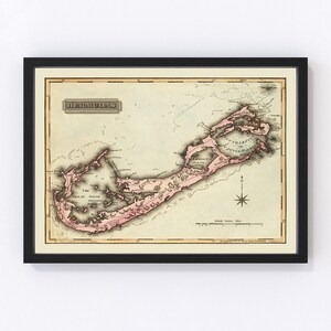 May include: An antique map of Bermuda, printed in black and white with pink highlights. The map shows the islands of Bermuda, with the names of the islands and towns labeled. The map is framed in a black frame.