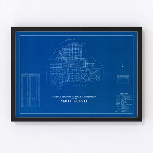 May include: A vintage blueprint map of Scott County, Indiana, created by the Indiana Highway Survey Commission. The map is printed on blue paper with white lines showing roads and towns. The map is framed in a black frame.