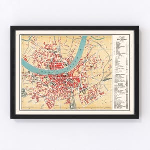 May include: Vintage map of the city of Cologne, Germany, printed in black, red, and blue on a cream-colored background. The map shows the city's streets, buildings, and the Rhine River. The map is titled "Plan de la Ville de Cologne" and includes a key with numbered locations.