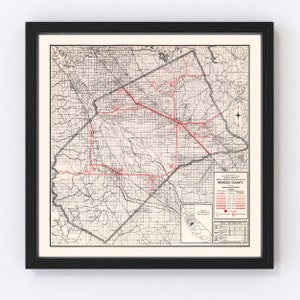 May include: A vintage map of Merced County, California, showing the county's roads, railroads, and townships. The map is printed in black and white with red lines and dots indicating roads and towns. The map is titled "Merced County" and includes a legend and a table of statistics.