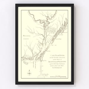 May include: Framed vintage map of the Cape Fear River, Brunswick and Wilmington, North Carolina. The map is in sepia tones with detailed illustrations of the river and surrounding areas. Includes text and a compass rose.