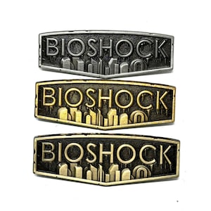 BioShock, logo emblem 2” enamel pin and magnet, available in antique bronze, ant gold and ant silver - classic fps game art