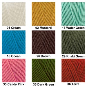 May include: A grid of nine yarn color samples labeled with numbers and names: 01 Cream, 02 Mustard, 15 Water Green, 16 Ocean, 26 Brown, 29 Khaki Green, 33 Candy Pink, 35 Dark Green, and 36 Terra. Each square displays a close-up of textured yarn.