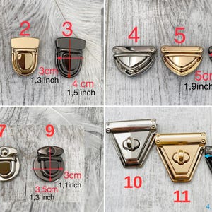 May include: A selection of metal bag clasps in different styles and finishes. The clasps are in silver, gold, and gunmetal colours. Measurements are provided in centimetres, with some clasps up to 5 cm wide.