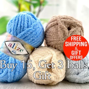 May include: Four balls of yarn in blue, beige, and light blue colors. The yarn is soft and fluffy. The label on one of the balls reads "alize Softy Mega". The text "Buy 15, Get 3 Balls Gift" is superimposed on the image.