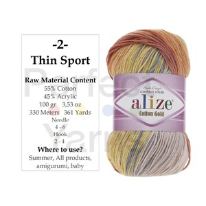 May include: A skein of Alize Cotton Gold yarn featuring a variegated color palette of orange, yellow, and grey. The label specifies 55% cotton, 45% acrylic, 100 grams, 3.53 ounces, 330 meters, 361 yards, with a needle size of 4-6 and hook size of 2-4.