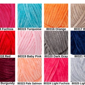 May include: A collection of colorful yarn skeins in various shades, including fuchsia, turquoise, orange, and beige. Each skein is labeled with a number and color name. Other colors include red, baby pink, dark gray, navy, burgundy, pale salmon, light fuchsia, and light gray.