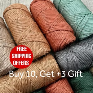 May include: A selection of colourful macrame cord spools in shades of beige, coral, teal, grey, and green. The spools are tightly wound, ready for crafting. A red circle with white text reads "FREE SHIPPING OFFERS".