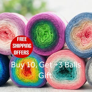 May include: A collection of seven yarn cakes arranged in a cluster, each featuring a multi-colored gradient transition. The yarn displays various color combinations including pink, purple, green, blue, and orange hues in a soft, textured fiber.