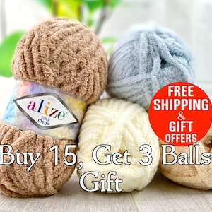 May include: A collection of soft, fluffy yarn balls in various colors, including beige, light blue, and cream. The yarn is labeled "alize Softy Mega." The image also includes the text "Buy 15, Get 3 Balls Gift."