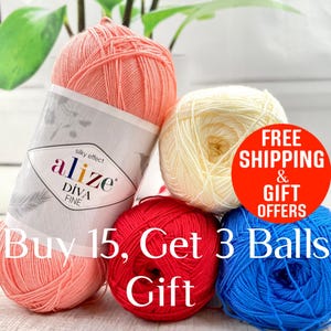 May include: Four balls of yarn in different colors: pink, cream, red, and blue. The pink ball has a label that reads "alize DIVA FINE silky effect". The text "Buy 15, Get 3 Balls Gift" is printed on the bottom of the image. A red circle with the text "FREE SHIPPING & GIFT OFFERS" is in the upper right corner.