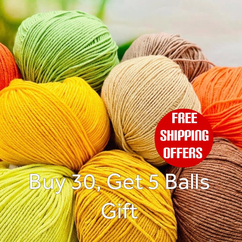 May include: A collection of round yarn balls in various colors including lime green, bright yellow, orange, beige, and brown. The yarn is wound into compact spheres with a visible twisted texture. The arrangement displays multiple skeins of fiber.