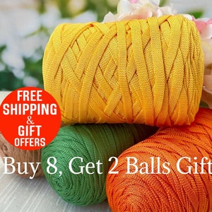 May include: A selection of colourful yarn spools. The top spool is a vibrant yellow, with a woven texture. Beneath it are green and orange spools. The image includes the text "Buy 8, Get 2 Balls Gift".