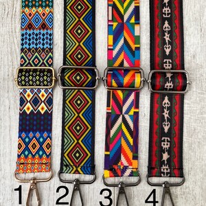 May include: Four adjustable bag straps with metal hardware and lobster clasps. Strap 1 features blue and orange diamonds. Strap 2 has yellow and blue geometric patterns. Strap 3 displays a colorful chevron design. Strap 4 shows red and black motifs.