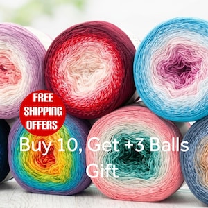 May include: Seven round balls of yarn arranged in a cluster, each featuring a multi-colored gradient pattern. The colors include shades of purple, pink, red, blue, green, yellow, and orange. The yarn is wound into tight, circular skeins.