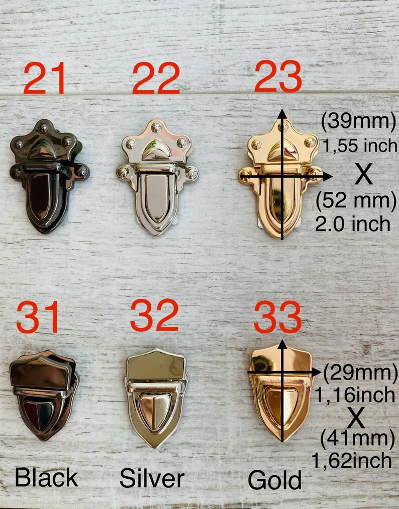 May include: A selection of decorative metal clasps in black, silver, and gold finishes. The clasps are shown in various shapes and sizes, with measurements in inches and millimeters. The image includes the numbers 21, 22, 23, 31, 32, and 33.