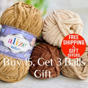 May include: Four balls of Alize Velluto yarn in shades of tan, beige, and dark brown. The yarn has a thick, plush, velvet-like texture. One ball features a label with the text Alize Velluto, soft and bright, and other printed information.