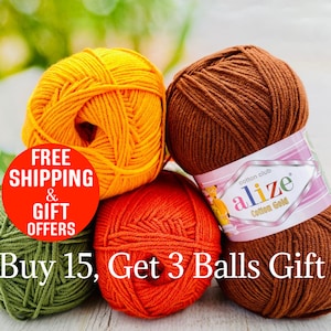 May include: Four skeins of Alize Cotton Gold yarn in yellow, brown, orange, and olive green. The brown skein features a label with the text cotton club alize Cotton Gold. A red circular graphic displays text about shipping and gift offers.