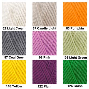 May include: A grid of nine yarn color samples featuring: 62 Light Cream, 67 Candle Light, 83 Pumpkin, 87 Coal Grey, 98 Pink, 103 Light Green, 110 Yellow, 122 Plum, and 126 Grass. Each square displays a textured, twisted fiber in a solid color.