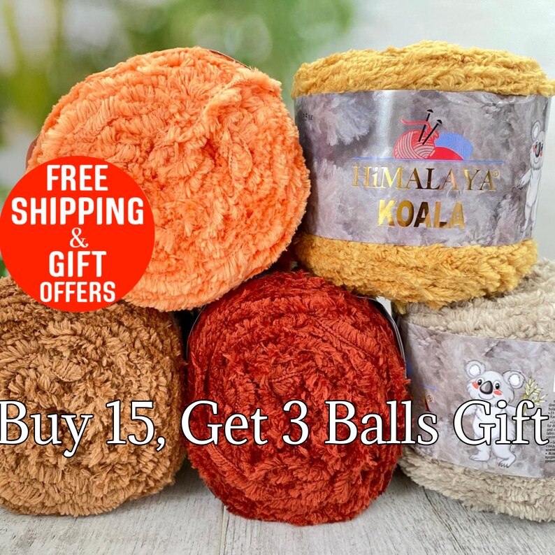 May include: Four skeins of fuzzy, textured yarn in shades of orange, mustard yellow, brown, and beige. The mustard yellow and beige skeins feature paper labels with the text Himalaya Koala and a koala illustration. The yarn has a soft, plush appearance.