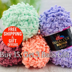 May include: A collection of colorful Himalaya Dolphin Loop yarn balls in shades of purple, mint green, coral, and burgundy. The image includes text that reads "Buy 15, Get 3 Balls Gift". The yarn is soft and textured, perfect for knitting and crochet projects.