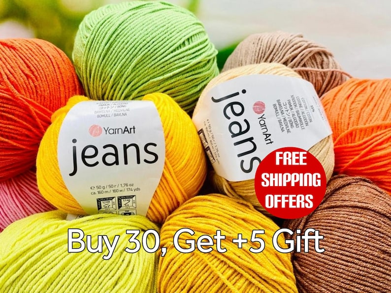 May include: A collection of YarnArt Jeans yarn balls in various colors including lime green, bright yellow, orange, and beige. Each ball features a white paper label with the text YarnArt jeans, 50g, 1.76 oz, and 160m, 174 yds printed on it.