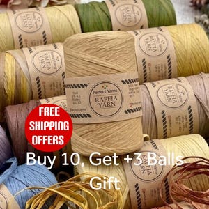 May include: Assortment of raffia yarn rolls in various colors, including beige, yellow, and green. Each roll is labeled with a brown paper band. The image showcases a variety of natural fiber yarn, ideal for crafting and DIY projects.