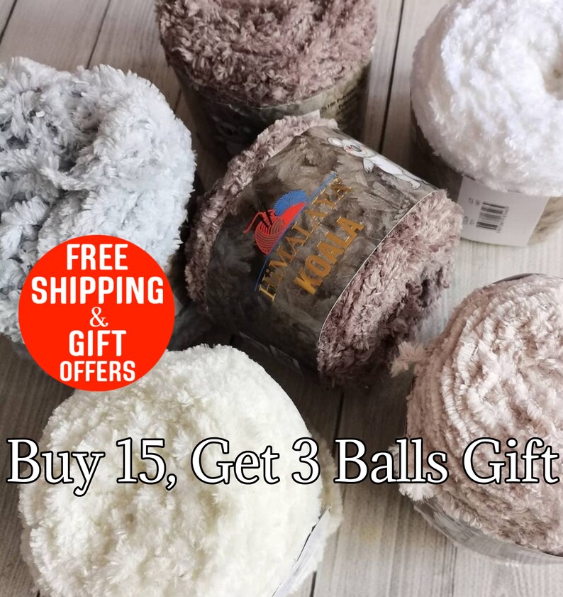 May include: Five balls of Himalaya Koala yarn in shades of white, light gray, and brown. Each ball features a soft, fuzzy, textured surface. The central yarn label displays the brand name Himalaya Koala with a koala illustration and logo.