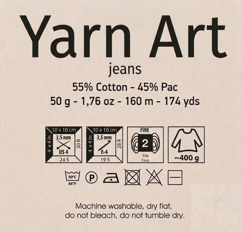 May include: Yarn Art jeans label featuring 55% Cotton and 45% Pac composition. It lists 50 g, 1.76 oz, 160 m, and 174 yds. Includes icons for 3.5 mm needles, 3.5 mm crochet hooks, gauge, weight, and care instructions: machine wash 30C, do not bleach.