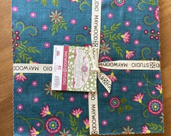 May include: A stack of 42 square fabric pieces tied with a branded ribbon. The fabric features a teal background with a repeating pattern of pink flowers, green vines, and small white dots. A tag reads Flower & Vine by Monique Jacobs Maywood Studio.