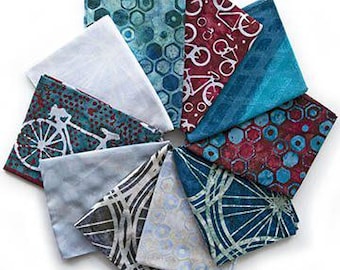 May include: A collection of folded fabric squares in various colors and patterns, including geometric shapes, bicycles, and abstract designs. The fabrics are arranged in a circular pattern, showcasing a variety of textures and hues.