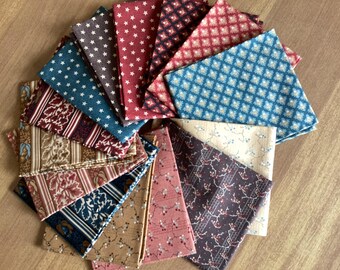 May include: A collection of folded fabric squares arranged in a circular fan pattern. The textiles feature various patterns including small stars, geometric diamonds, floral vines, and striped botanical motifs in shades of red, blue, brown, and cream.