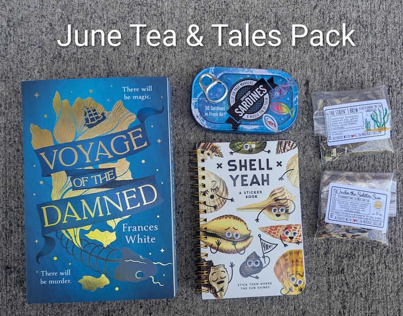 May include: A flat lay of a "June Tea & Tales Pack" featuring a book titled "Voyage of the Damned", a sardine tin, a sticker book, and two tea packets. The book is blue with gold lettering. The sticker book is white with colorful shell illustrations.