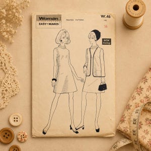 May include: A vintage sewing pattern labelled "Woman EASY-MAKES" with illustrations of two women in dresses. The pattern includes sizing details and is printed on aged paper. Sewing notions such as buttons and a measuring tape are also visible.