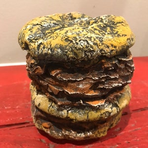 Cement double cheeseburger sculpture by Concrete Collectibles