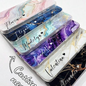 May include: A stack of custom phone cases with marble designs in various colors, including pink, blue, and purple. Each case features a personalized name in cursive font with a small heart. The text "Customize Case" is at the top.