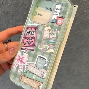 May include: Clear phone case with a green and white checkered pattern. The case features stickers of books, a pink bow, a coffee cup, and the text "BOOKS", "JUST A GIRL", and "WHO LOVES BOOKS".