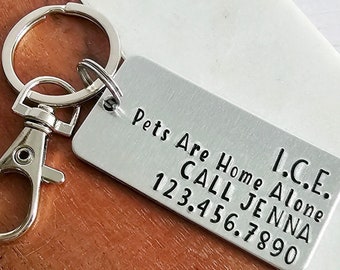 May include: Silver keyring with a metal tag that reads "I.C.E. Pets Are Home Alone Call Jenna 123.456.7890".