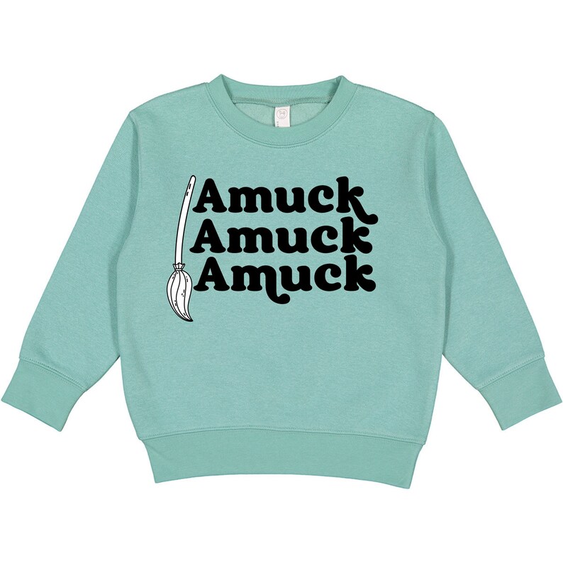 May include: A light blue sweatshirt with a black graphic of a broom and the text "Amuuck Amuuck Amuuck".