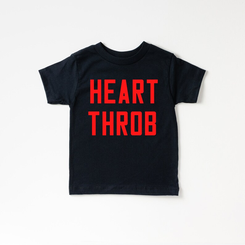 May include: A black t-shirt with the words "HEART THROB" printed in red.