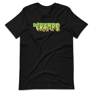 May include: Black t-shirt with a green and yellow "The Cramps" logo.