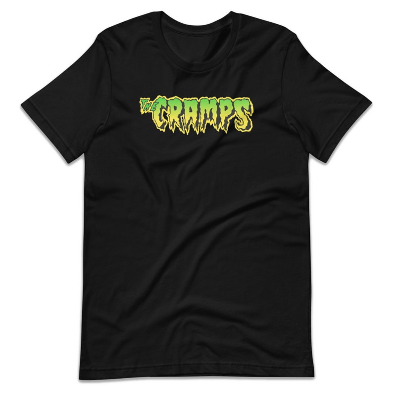 May include: Black t-shirt with a green and yellow "The Cramps" logo.