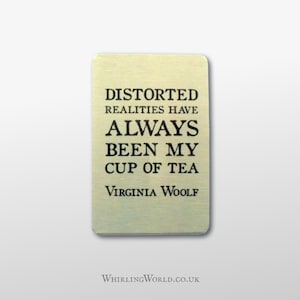 May include: A gold metal bookmark with the quote "Distorted realities have always been my cup of tea" by Virginia Woolf.