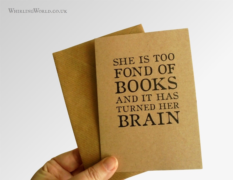 May include: A brown card with the text "She is too fond of books and it has turned her brain" printed in black.